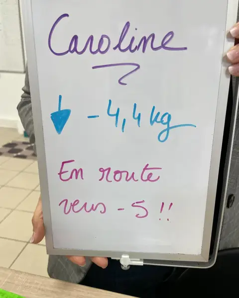 Une membre d’Aloha Nutriclub avec l’ardoise de son bilan